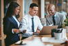 a group of people sitting at a desk